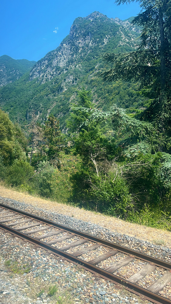 Mountain scenery and railway tracks in the Roya Valley, seen from the Train des Merveilles between Nice and Breil-sur-Roya.